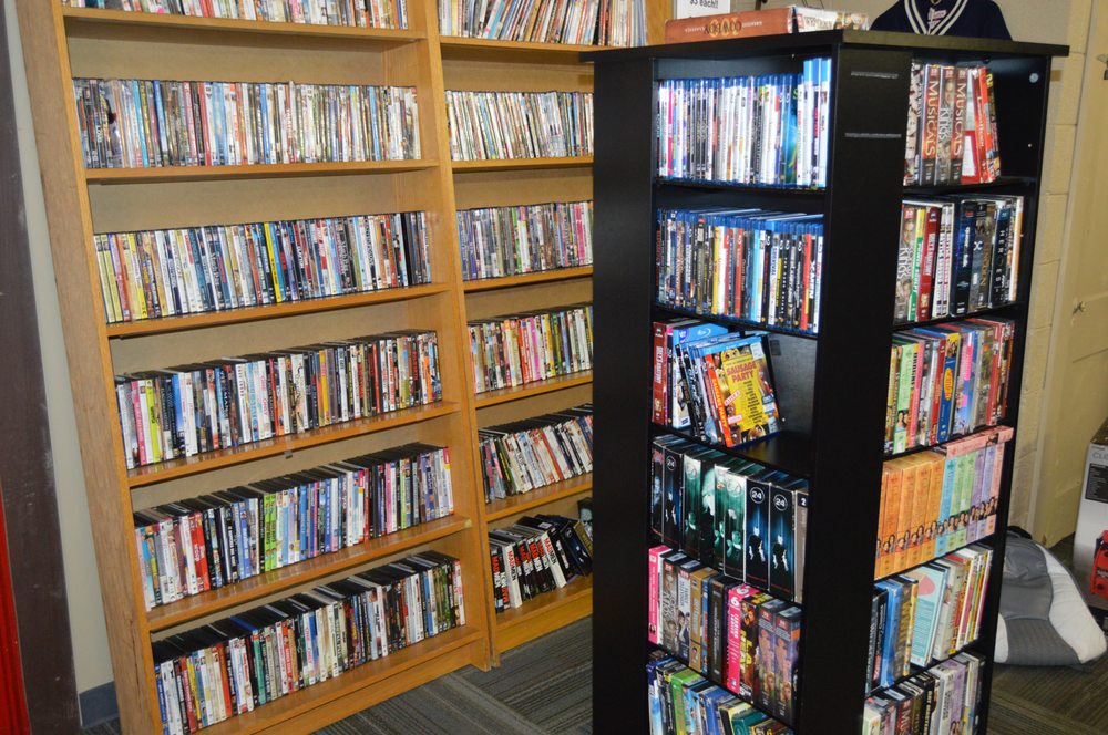 Tall bookshelves fully stocked with DVDs and Blu-ray movies