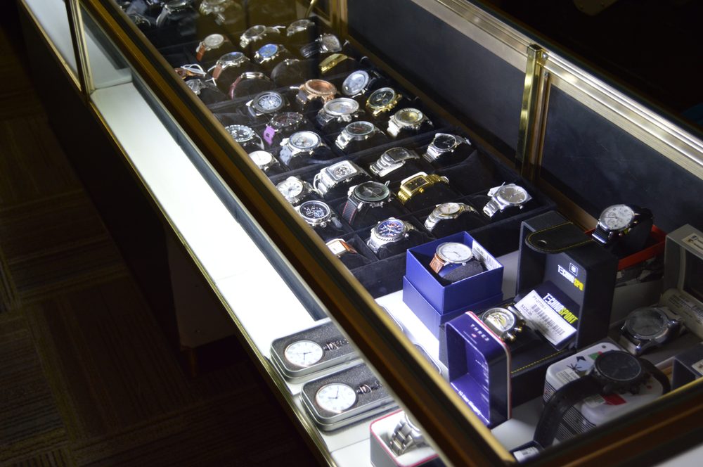 Glass display case filled with luxury and sport wristwatches at Golden Goat in Richmond, Virginia